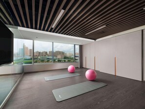 A modern room with large windows, exercise mats, and pink exercise balls. - Novotel Kunming Yunjin (Kunming)