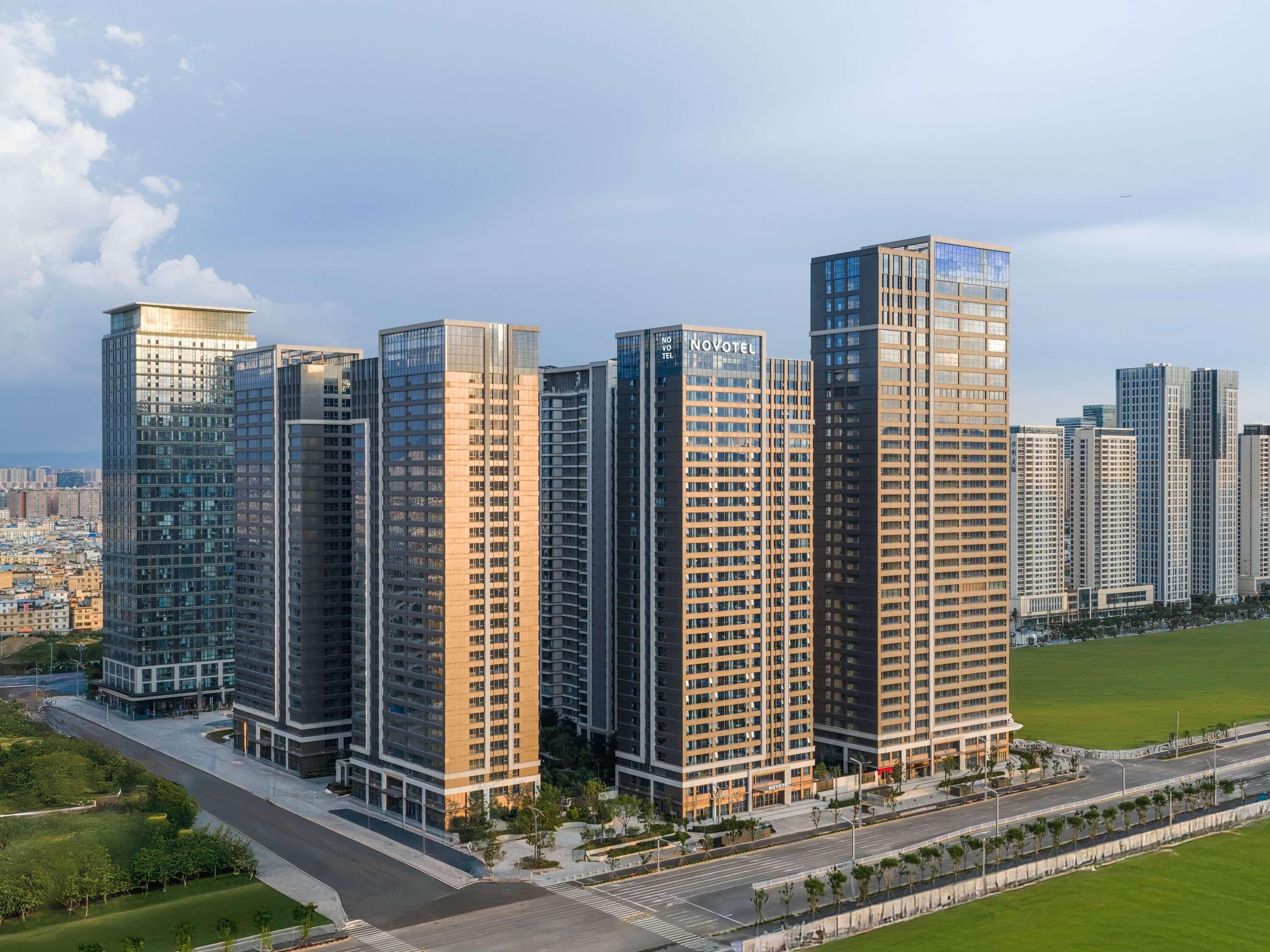 A high-rise hotel with multiple floors, a modern glass facade, and a flat roof.