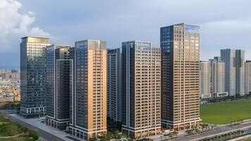 A high-rise hotel with multiple floors, a modern glass facade, and a flat roof.