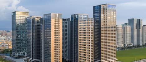 A high-rise hotel with multiple floors, a modern glass facade, and a flat roof.
