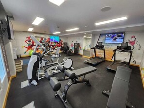 A gym with various exercise equipment, including treadmills and weight machines. - Tulip Inn Majan Hotel (Salalah)