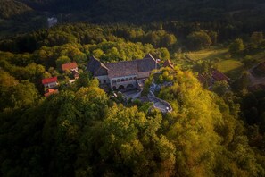 An aerial view of a historic building surrounded by dense forest. - Lukec Homestead Adventure Studio Meta, Kostel, Slovenia (Kostel)