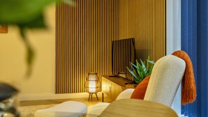 A modern living room with a TV, a lamp, and a sofa. - Micklegate Hideaway  -  Sleeps 4 Guests  in 2 Bedrooms (York)
