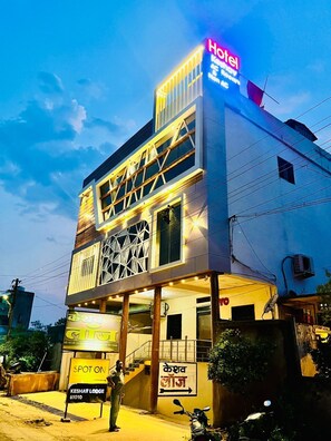 A hotel with a modern facade, a prominent 'Hotel' sign, and a 'Spot on' sign indicating a nearby location. - Hotel Keshav (Savner)