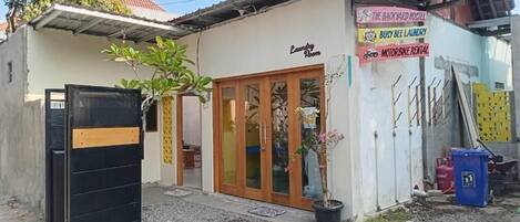 A laundry room with a wooden door and a small potted plant.