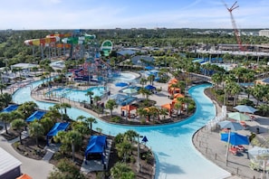 A water park with multiple pools, slides, and a large wave pool. - 8070-304 Luxury 2BR Apt Kissimmee Orlando Disney (Kissimmee)