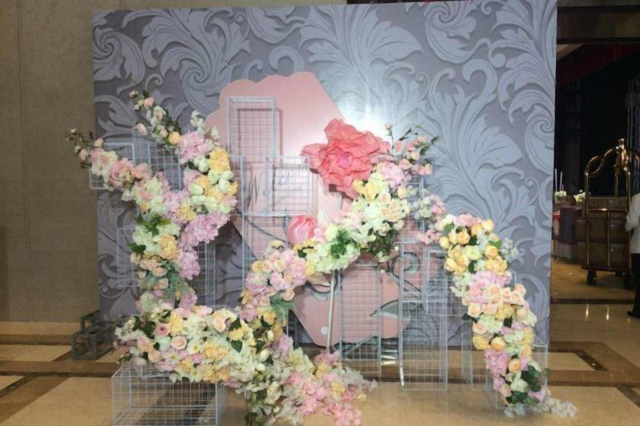 A floral arrangement with a heart-shaped design, possibly for a special event or decoration.