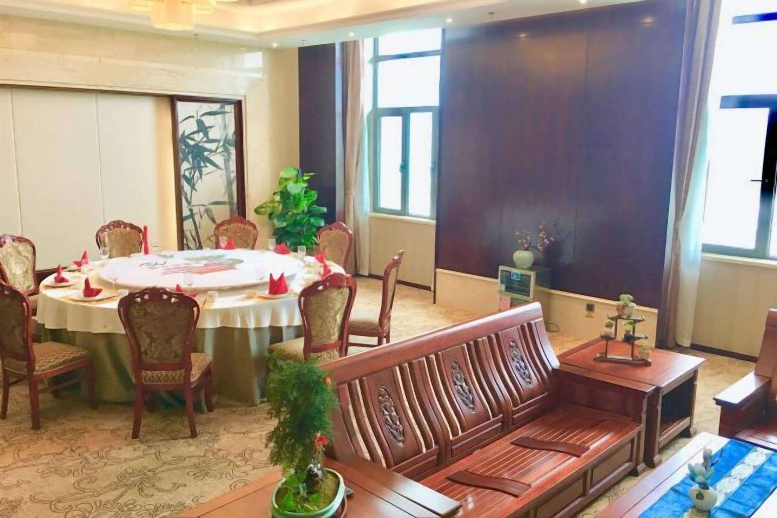 A dining area with a round table, chairs, and a bench.