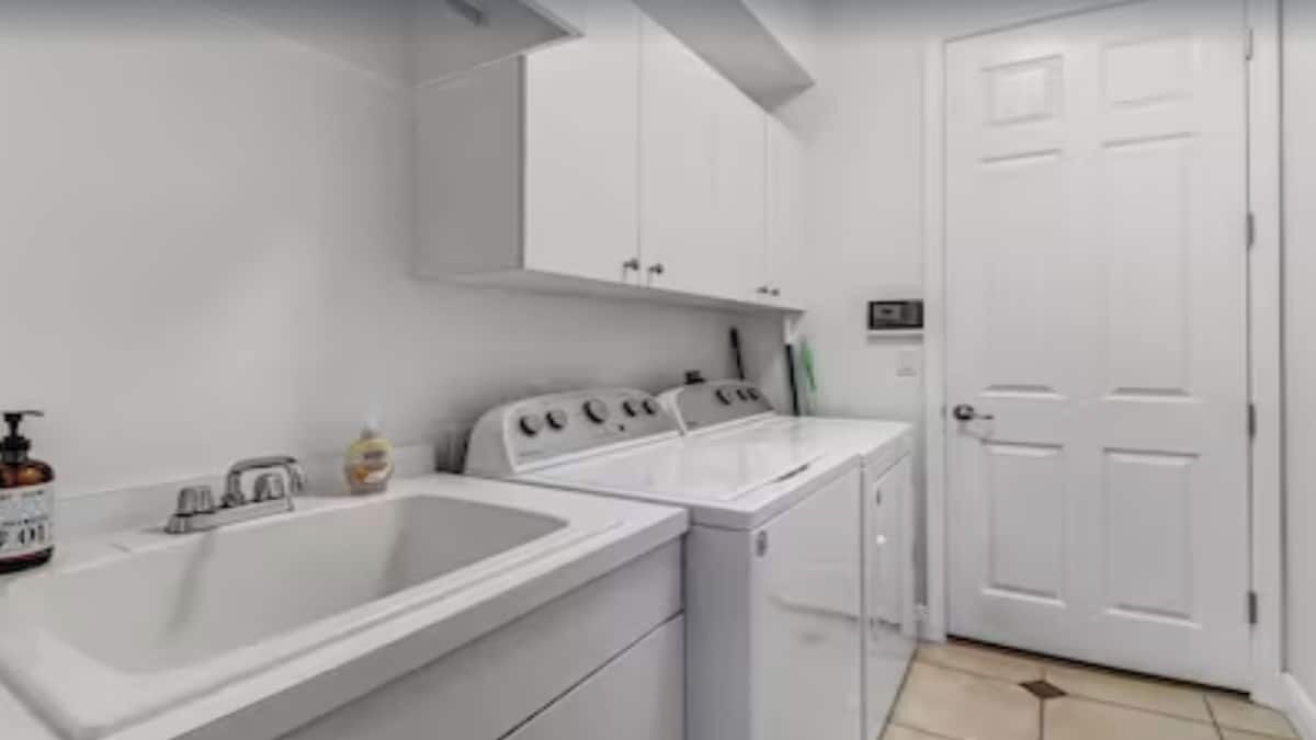 A laundry area with a washing machine, dryer, and sink.