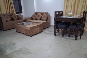 Apartment | Living room | 32-inch flat-screen TV with cable channels - Metrolink Apartment & Suites-East Of Kailash (New Delhi)