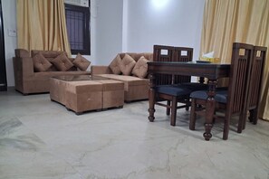 Apartment | Living room | 32-inch flat-screen TV with cable channels - Metrolink Apartment & Suites-East Of Kailash (New Delhi)