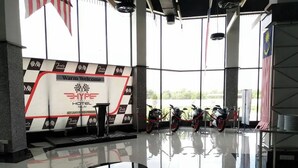 A hotel lobby with a checkered floor, a stage with a 'Welcome' banner, and motorcycles parked in the background. - Arafah Hotel Nilai (Nilai)