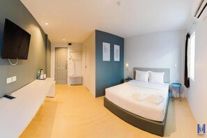 A modern hotel room with a large bed, a flat-screen TV mounted on the wall, a small bedside table, and a window providing natural light. - Lofts At Hang Kasturi Kuala Lumpur (Kuala Lumpur)