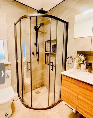Shower, hair dryer, towels, shampoo