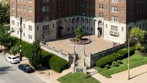 A large brick building with multiple floors, a central courtyard, and a flagpole. - Cozy 1BR Retreat in Central West End with Fireplace, Sofa Bed & City Views (St. Louis)
