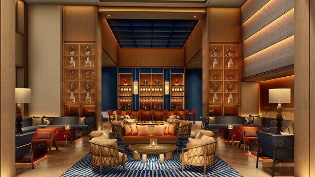 A spacious lobby with a central seating area, a bar, and a large bookshelf. - Kaban Hotel & Casino Boracay (Boracay Island)