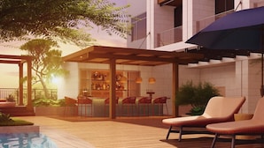 A modern outdoor patio with a pool, wooden deck, and a bar area with seating. - Kaban Hotel & Casino Boracay (Boracay Island)