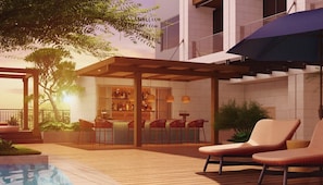 A modern outdoor patio with a pool, wooden deck, and a bar area with seating. - Kaban Hotel & Casino Boracay (Boracay Island)