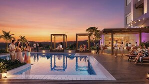 A rooftop pool area with a clear view of the sunset, a bar/lounge area, and seating arrangements. - Kaban Hotel & Casino Boracay (Boracay Island)