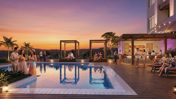 Ein Poolbereich auf dem Dach mit freiem Blick auf den Sonnenuntergang, eine Bar oder Lounge sowie Sitzgelegenheiten.