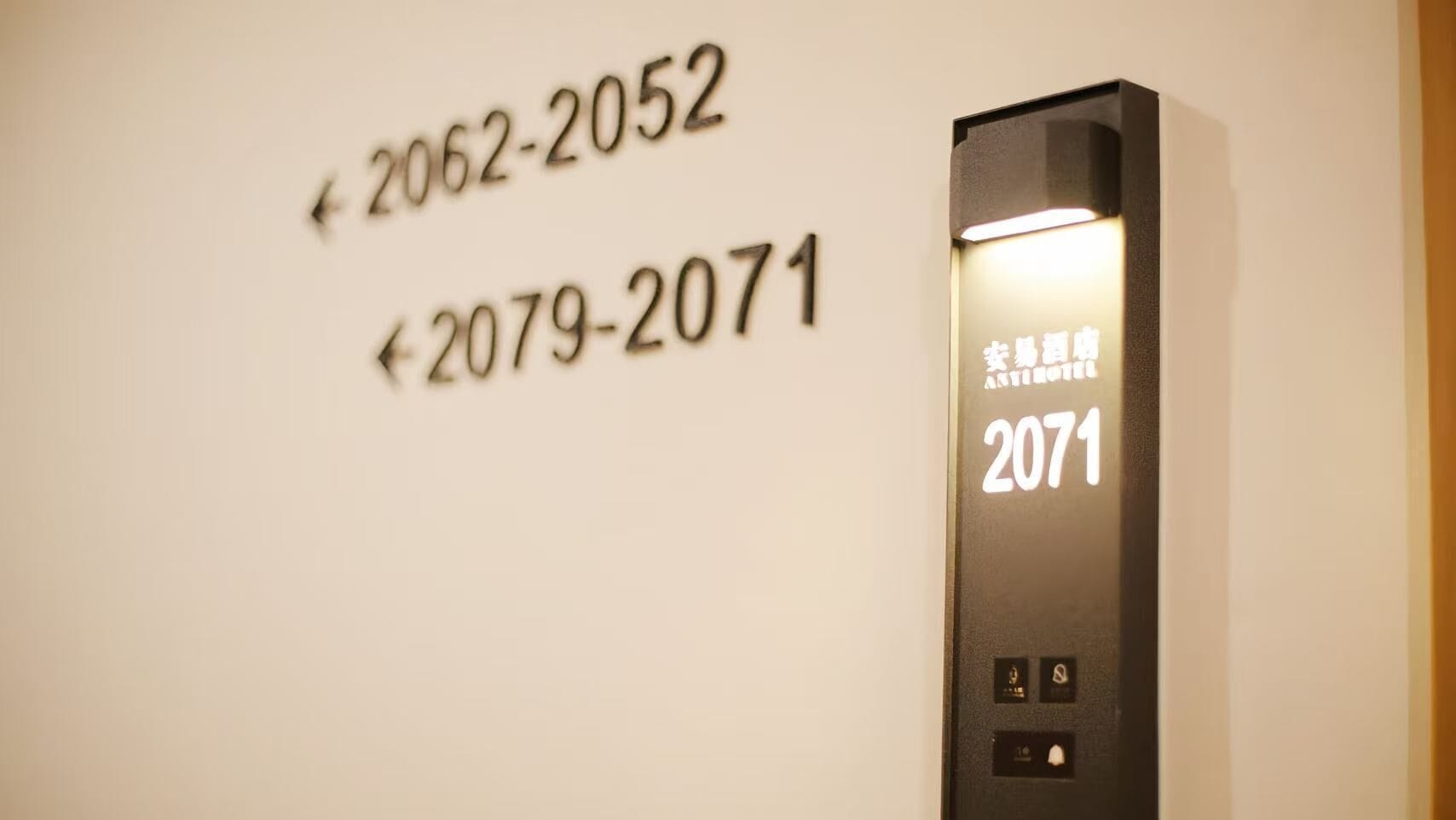 An elevator with floor numbers 2062-2052 and 2079-2071 visible on the wall.