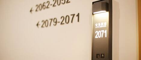 An elevator with floor numbers 2062-2052 and 2079-2071 visible on the wall.