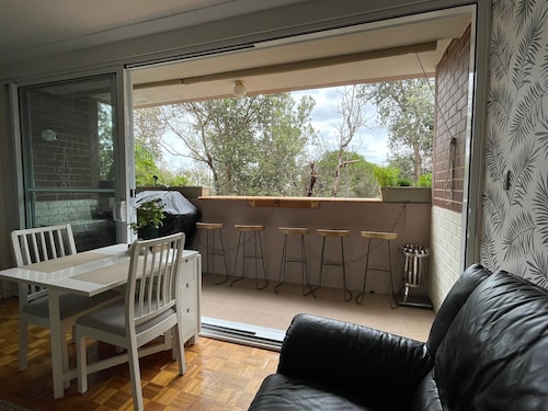 Central Location to beach & shops, quiet, balcony & bar & bar stools. Tree view.