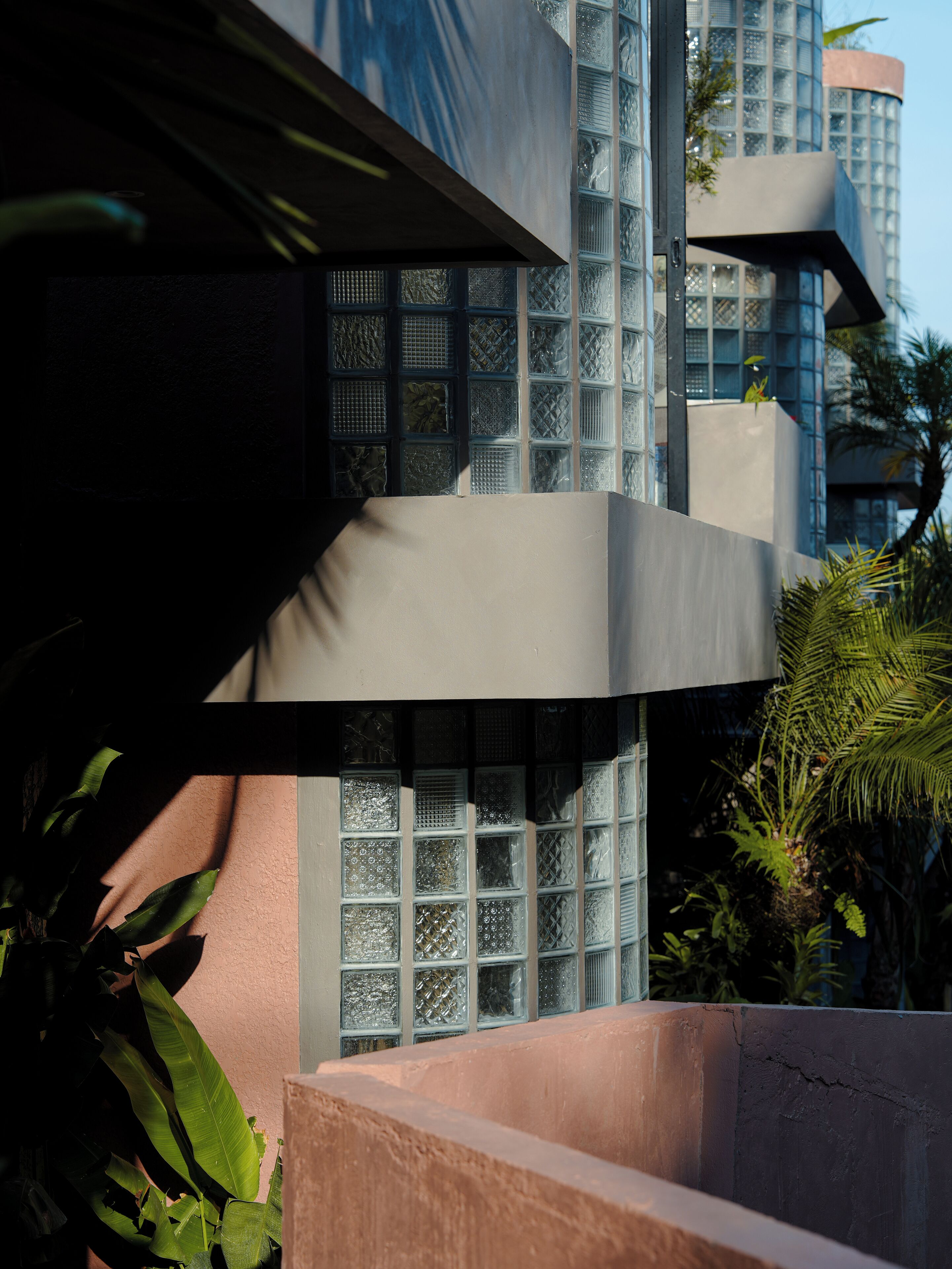 A modern building with a unique architectural design, featuring a combination of glass and concrete elements.