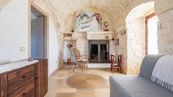 Family Villa, Multiple Bedrooms (Trullo ConoSolo With Pool) | Living area | 21-inch Smart TV with digital channels, fireplace
