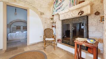 Family Villa, Multiple Bedrooms (Trullo ConoSolo With Pool) | Living area | 21-inch Smart TV with digital channels, fireplace