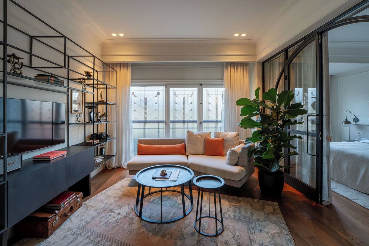 A modern living room with a sofa, coffee table, and TV.