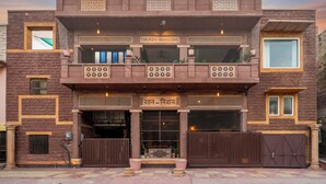 A two-story building with a sign reading "MUNSHI MANSIONI" and "Ratan - Nivas". - The Munshi Mansion (Jodhpur)
