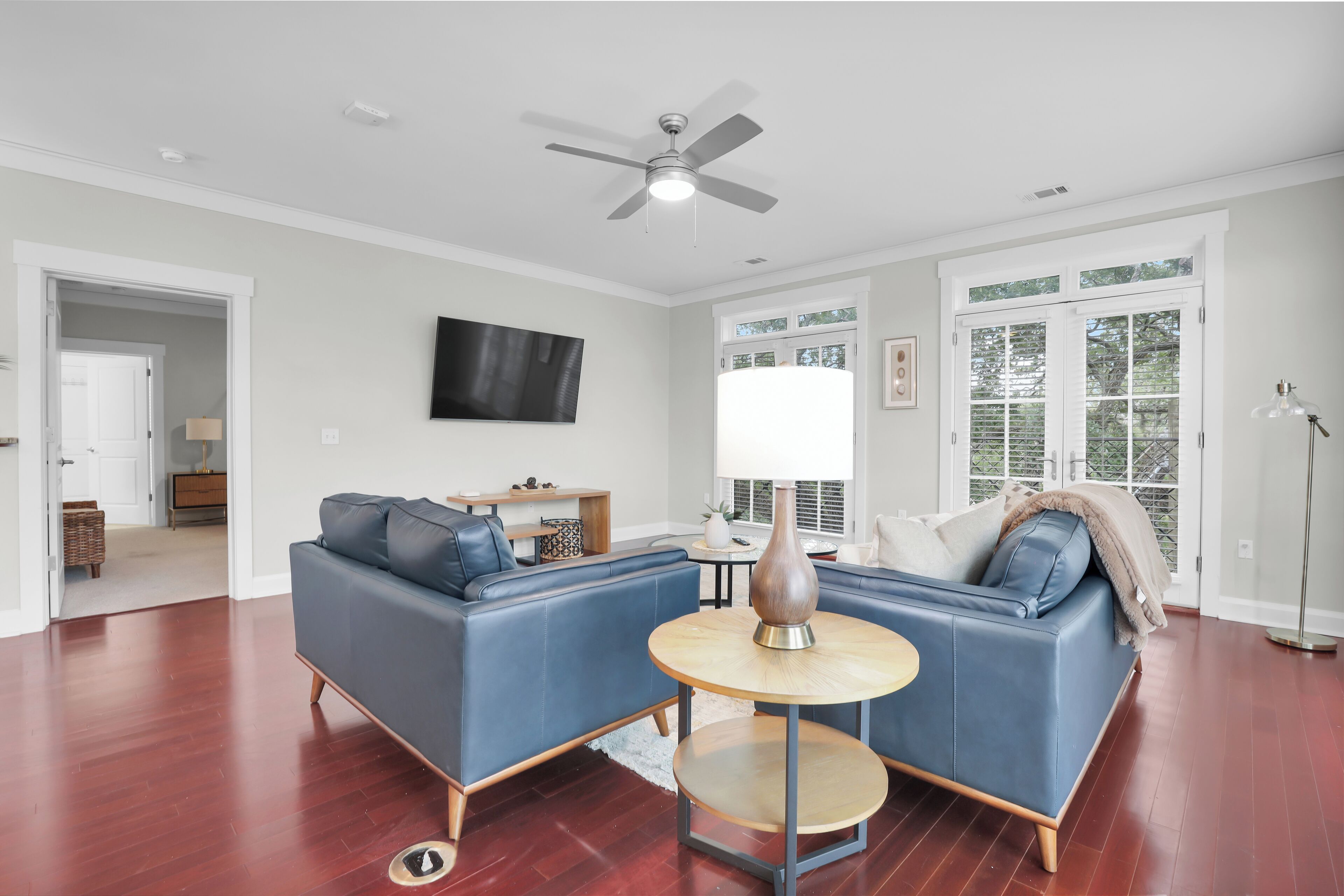 Spacious open living and dining area with modern decor, large windows, and natural light.