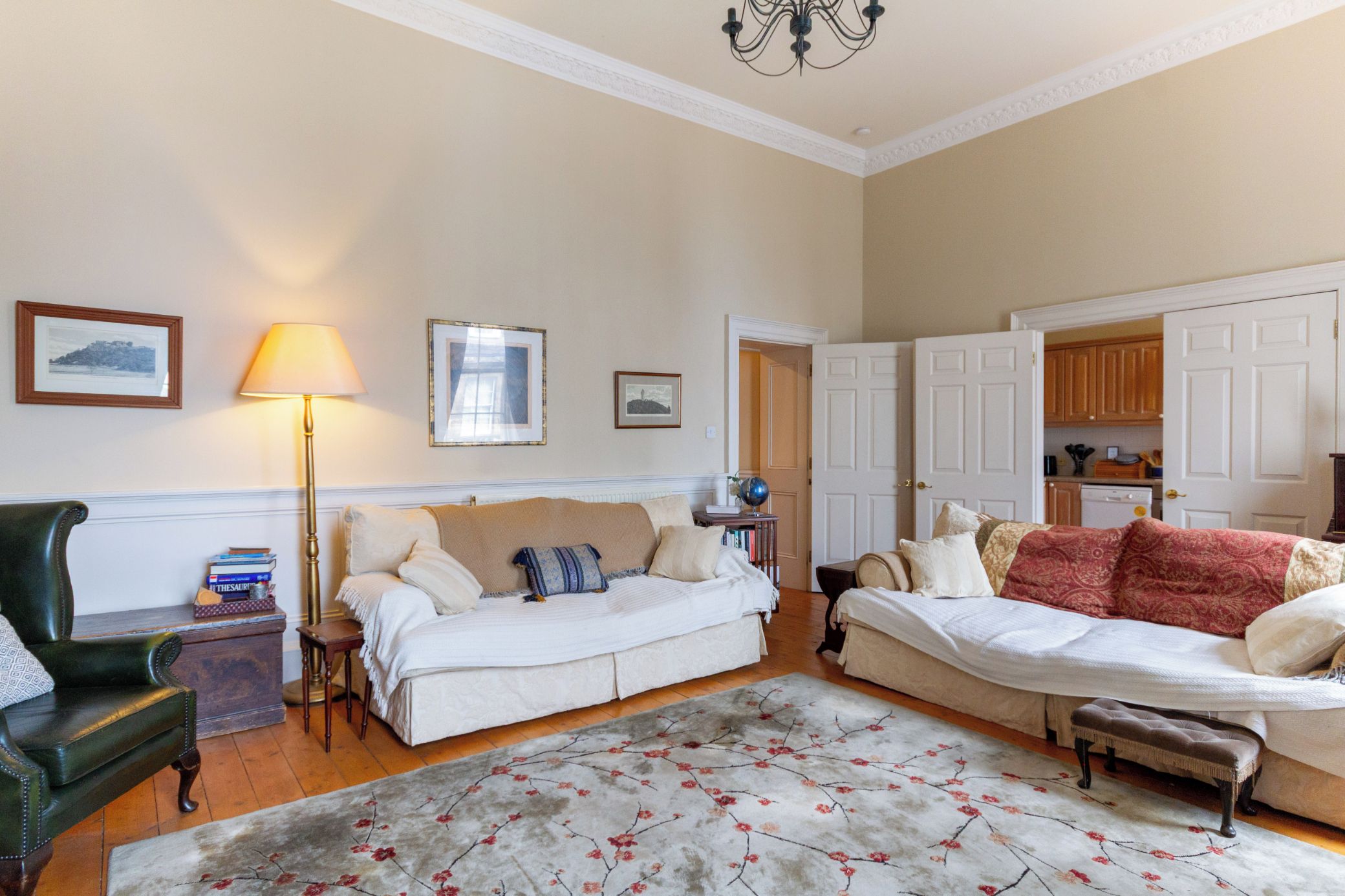 A living room with two sofas, a lamp, a globe, and a rug.