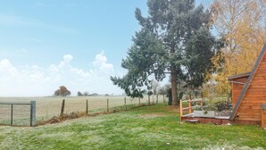 A fenced property with a wooden structure, a large tree, and a grassy field. - Awesome home in Herry with heated swimming pool (Herry)