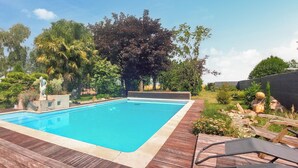 A rectangular swimming pool with a wooden deck surrounding it. - Awesome home in Herry with heated swimming pool (Herry)