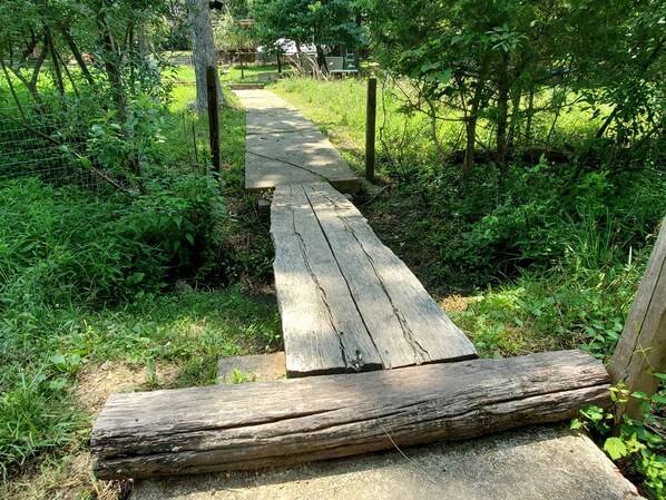 A wooden pathway leading through a wooded area.
