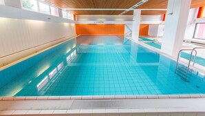 An indoor swimming pool with tiled walls and a wooden ceiling. - Berolina 110 - Ostseemuschel - The "Ostseemuschel" ... a rarity with 2 (Dahme)