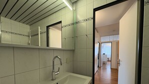 A bathroom with a sink, mirror, and tiled walls. - Berolina 110 - Ostseemuschel - The "Ostseemuschel" ... a rarity with 2 (Dahme)
