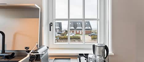 Fridge, stovetop, dishwasher, coffee/tea maker