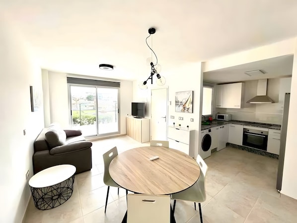 A modern kitchen with a built-in oven, microwave, and washing machine.