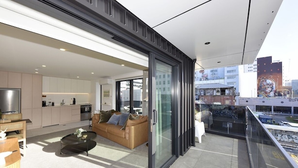 A modern apartment with a kitchen, living room, and balcony with city views. - Free Carpark & Stylish City Apartment Near Te Kaha (Christchurch)