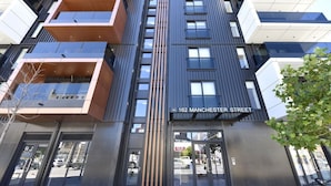 A modern building with a sign reading '162 Manchester Street.' - Free Carpark & Stylish City Apartment Near Te Kaha (Christchurch)