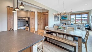 A spacious kitchen with a large island, wooden cabinets, and pendant lighting. - Springview Meadows: Lux Condo with Private Hot Tub, Near Trails & Winter Park (Fraser)