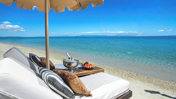 A beachside hotel room with a bed, a table with food, and a clear view of the sea. - Adriana Beach (Pefkochori)