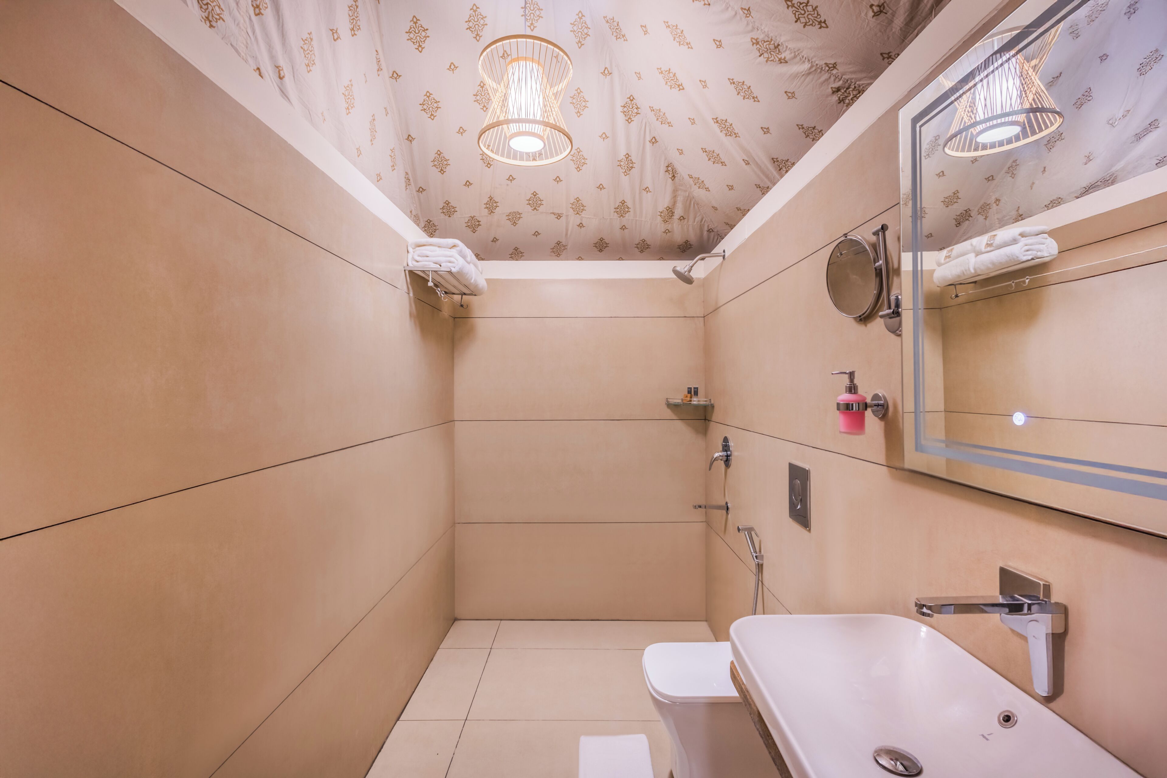 A small, modern bathroom with a toilet, sink, and shower.