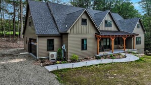 A two-story house with a covered porch and a garage.