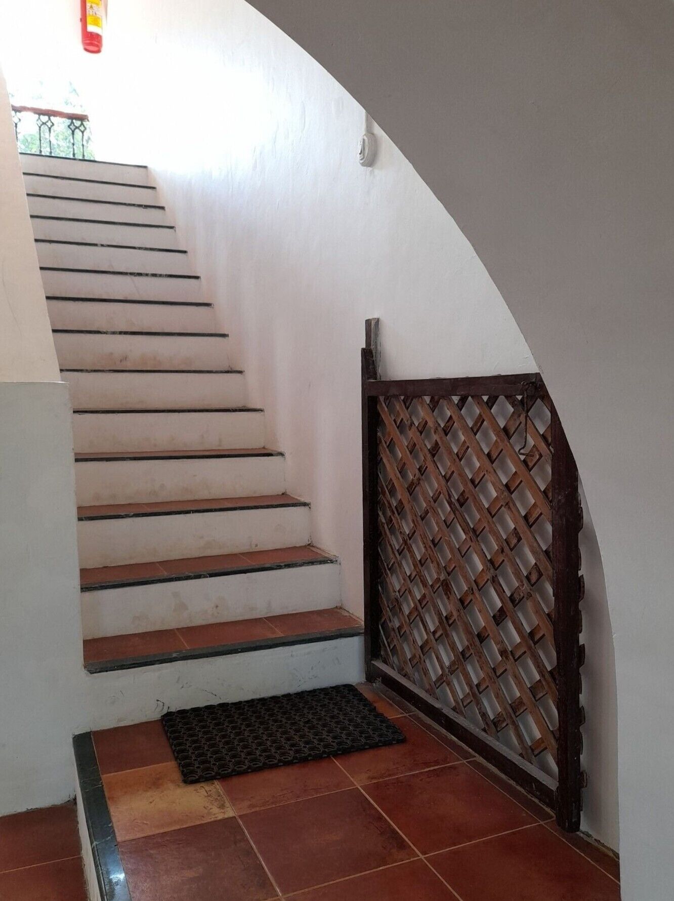 A staircase with a metal gate at the bottom.