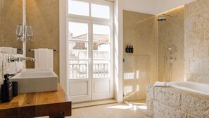 A bathroom with a large sink, a shower, and a view of the outside. - Ando Living - Corpo Santo House - 401 (Lisbon)