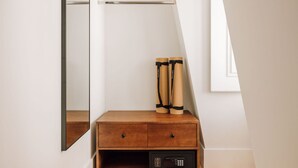 A wooden dresser with two pairs of black and brown roller skates on top. - Ando Living - Corpo Santo House - 501 (Lisbon)